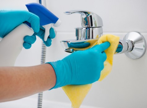 Local cleaner washing windows on a Swiss Cottage flat